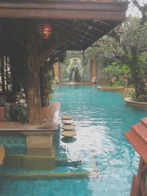 An Outdoor Swimming Pool With Benches And Trees In The Backgrouds