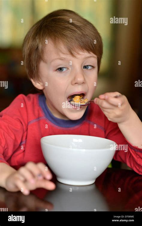 A Boy Aged Five Years Old Eating A Bowl Of Cereal Stock Photo Alamy