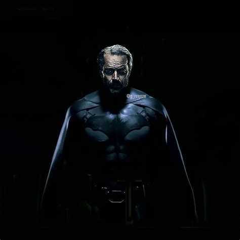 a man dressed as batman standing in the dark