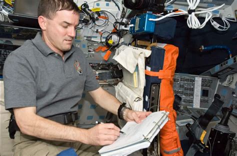 Astronaut using space pen - Our Planet