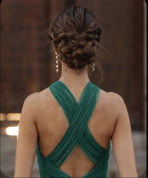 The Back Of A Woman S Green Dress With Braids On Her Head And Shoulders