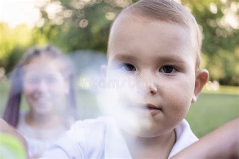 Little Boy Inflates And Bursts Soap Bubbles Cute Funny Kid Is Playing