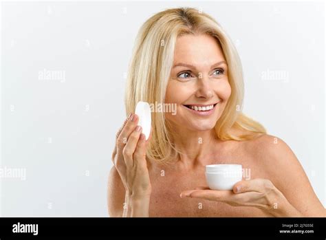 Skincare Routine Middle Aged 50s Woman Holding Jar With Anti Aging