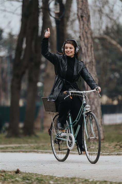 Stylish Young Businesswoman Enjoying A Bike Ride In The Park Stock