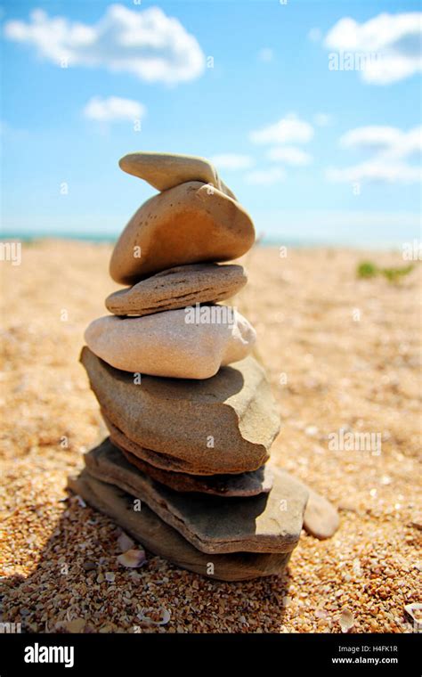 The Balanced Design Of Seashore Stones On The Beach Against The Sand