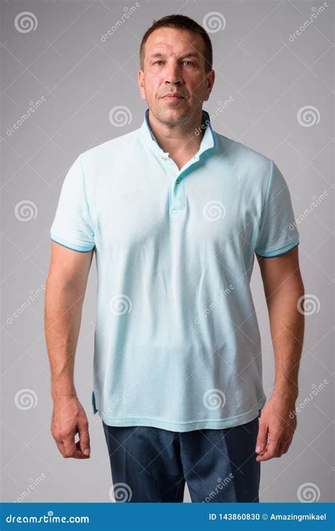 Portrait Of Macho Mature Man Looking Strong And Muscular Stock Photo