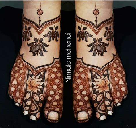 The Feet And Hands Of A Woman With Henna Designs On Their Legs Both