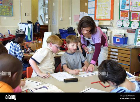 Primary School Children Studying Anatomy In Classroom With Teacher