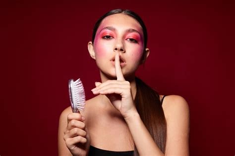 Premium Photo Sexy Brunette Woman With A Comb Bright Makeup Posing Black Jersey Cropped View