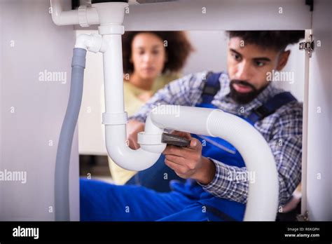 Woman Fixing Plumbing Under Sink Hi Res Stock Photography And Images