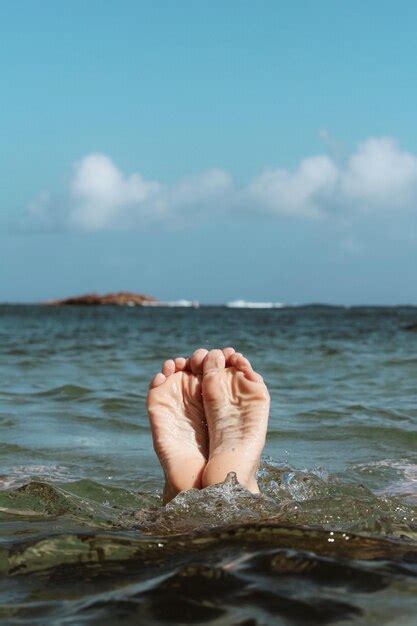 Premium Photo Low Section Of Person In Sea