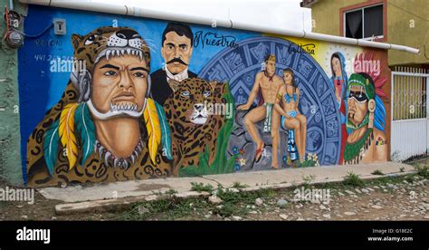 Urban art depicting Mexican Indians, modern Mexican man and Virgin Mary ...