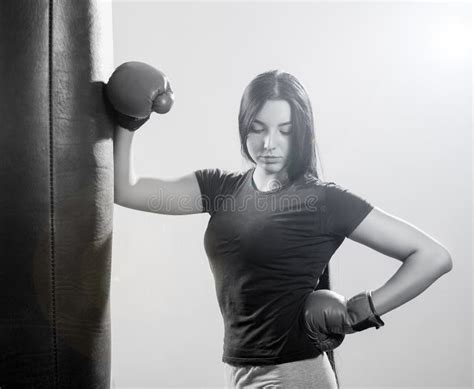 Brunette Woman In Boxing Gloves And Body Hitting Pear Stock Photo