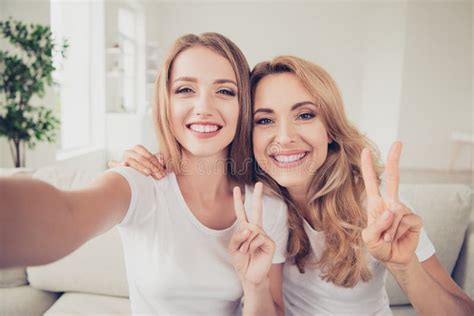 Close Up Photo Of Two People Mum And Teen Daughter Holding Hands Arms