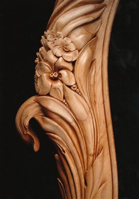 An Intricately Carved Piece Of Wood With Flowers On It