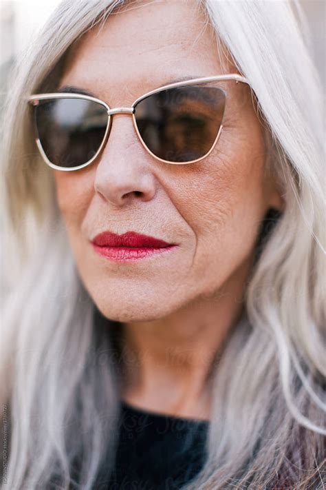 Closeup Portrait Of A Mature Woman With Grey Hair Wearing Sunglasses