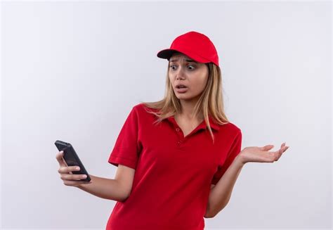 Repartidor Joven Asustado Con Uniforme Rojo Y Gorra Sosteniendo Y