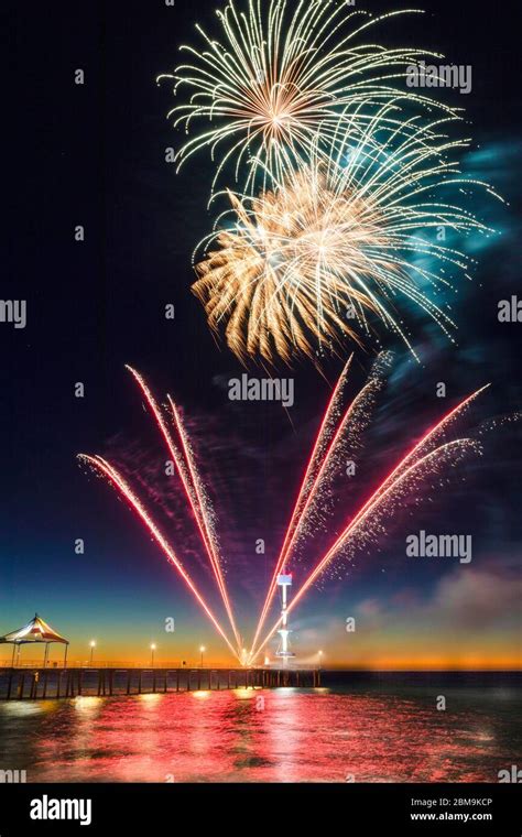 Colourful New Years Fireworks Display Lighting Up The Sky And Water Off