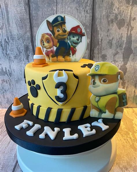 A Three Tiered Cake Decorated With Paw Patrol Characters