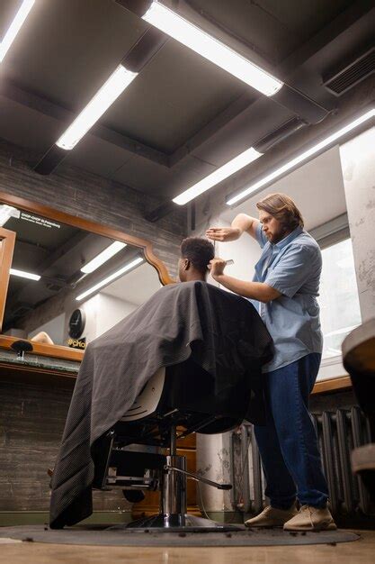 Hombre de tiro completo cortándose el pelo Foto Gratis