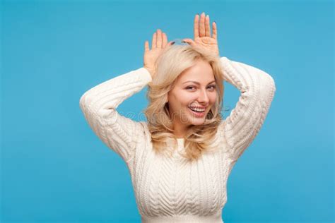 Beautiful Playful Woman With Curly Blond Hair Holding Hands Above Head