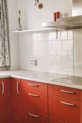 Corner Cupboards And Table With Chairs Located In Red Kitchen Of