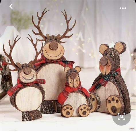 Three Wooden Reindeer Figurines Sitting Next To Each Other On Top Of A