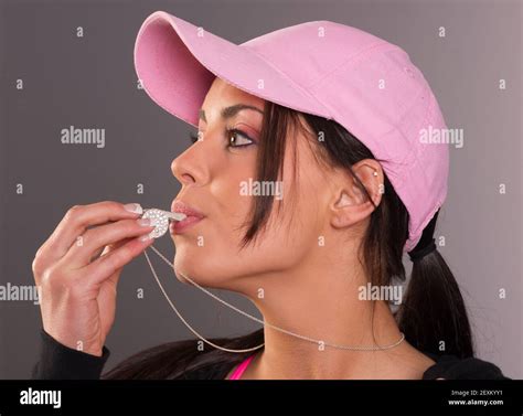 Attractive Brunette Female Blows Whistle Pink Ball Cap Whistleblower Stock Photo Alamy