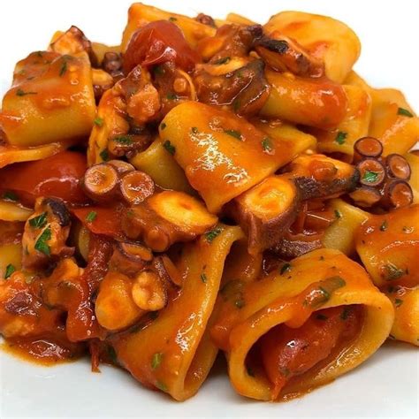 Pasta With Mushrooms And Sauce On A White Plate