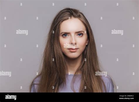 Confident Brunette Woman With Healthy Skin Poses Indoors Looking