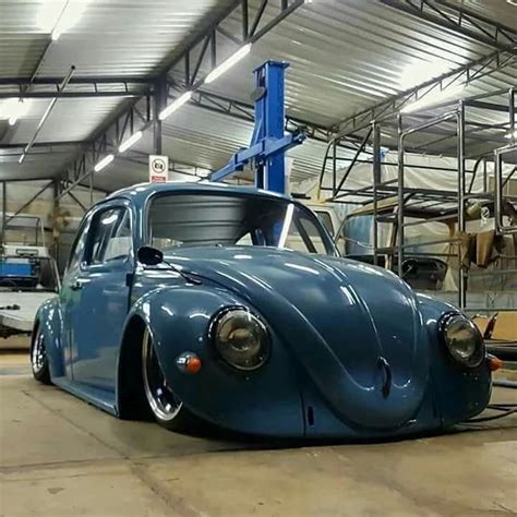 An Old Blue Car Is Parked In A Garage