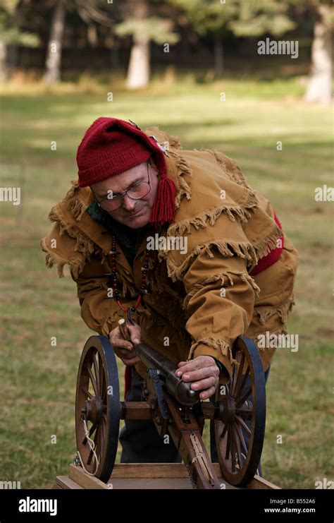 Man wearing trapper costume demonstrating black powder cannon at Steam ...