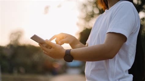 Premium Photo A Person Wearing A White Shirt Is Holding A Phone And