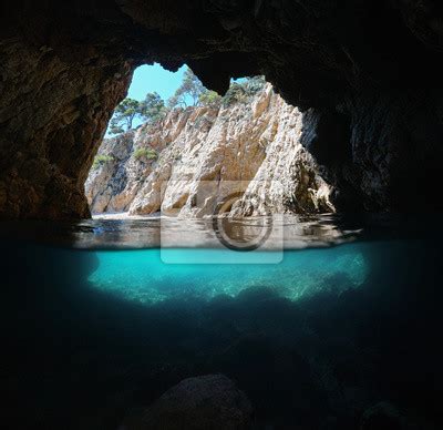 Sea Cave On Rocky Shore Split View Over And Underwater Mediterranean