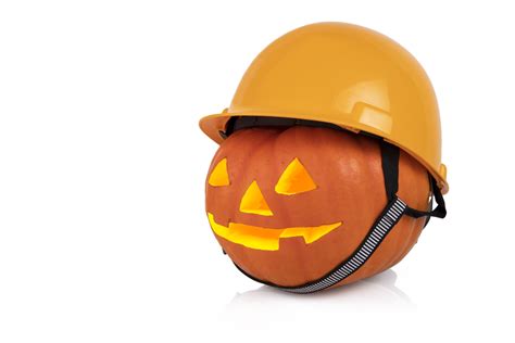 Orange Pumpkin With Glowing Eyes In A Yellow Construction Helmet Hard