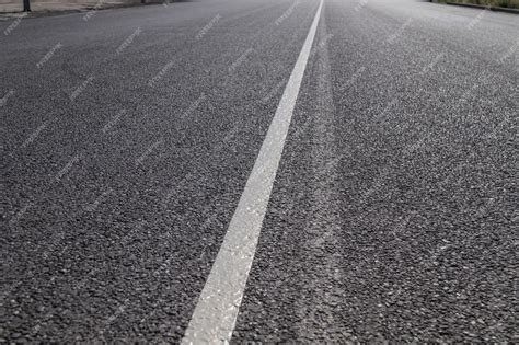 Premium Photo | Fresh white paint on the asphalt Road markings