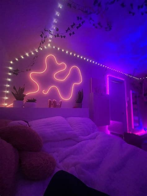 A Bedroom With Purple Lights And A Bed In The Foreground There Is A