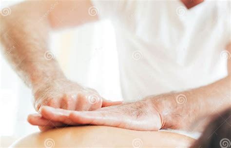 Masseurs Man Hands Doing Massage Manipulations On The Scapula Area Zone