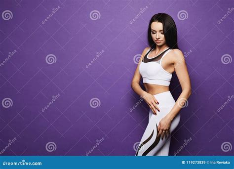 Sporty And Brunette Fitness Model Girl With Blue Eyes And Perfect Body In Sport Outfit Tight
