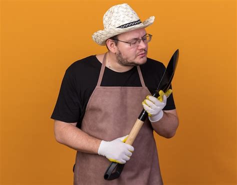 Free Photo Pleased Young Male Gardener Wearing Gardening Hat And