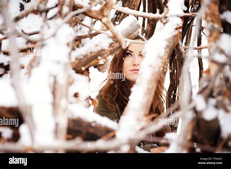 Woman Seen Through Snow Covered Branches Stock Photo Alamy