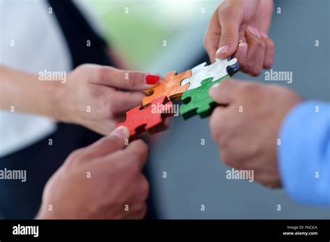 Group Of Business People Assembling Jigsaw Puzzle Stock Photo Alamy