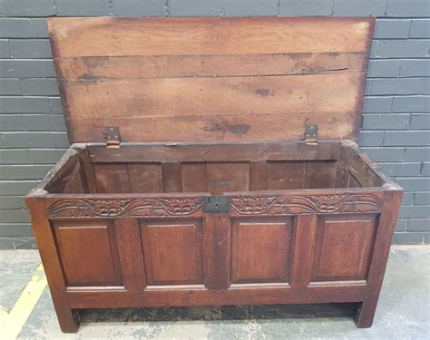 Lot 18th Century Oak Chest With Hinged Panel Top Foliate Carved Frieze And Unusually Side