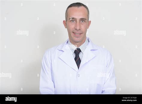 Portrait Of Mature Handsome Man Doctor Against White Background Stock