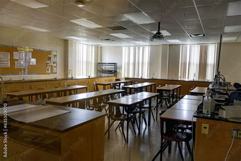 Science laboratory classroom - wooden lab tables with black countertops and sinks - windows with ...