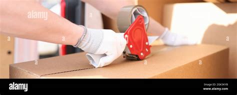 Man Seals Box With Adhesive Tape Dispenser Stock Photo Alamy