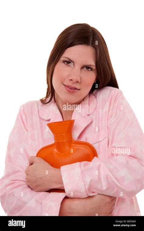 Woman Wearing Pyjamas Cuddling A Hot Water Bottle For Comfort To Keep