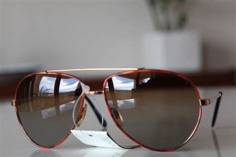 Gold Aviator Frame With Shades Of Red Lenses Frame And With Golden Brown Polarizing Len