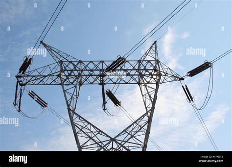 High Tension Power Lines Against Blue Sky Stock Photo Alamy
