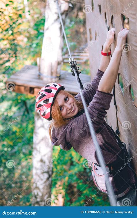 Happy Girl Women Climbing Gear In An Adventure Park Are Engaged In